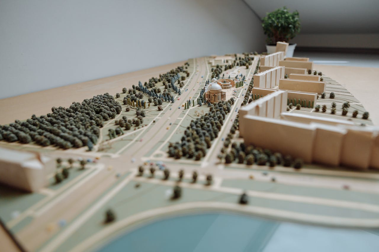 Close-up of an architectural miniature model depicting an urban layout with buildings, roads, and greenery.